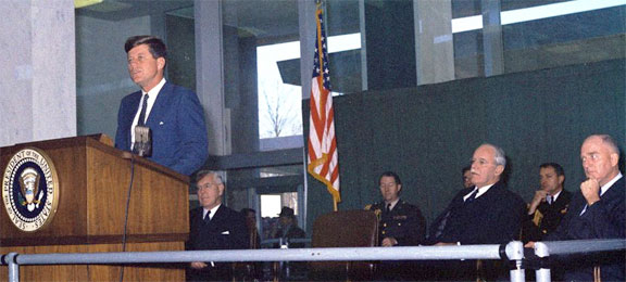 President John F. Kennedy, JFK, at podium. At the far right of photo left to right are CIA Director Allen Welsh Dulles, AWD, and his Deputy CIA Director Charles Cabell. Image from JFK Archive.